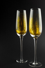Composition of close up of new years champagne on black background
