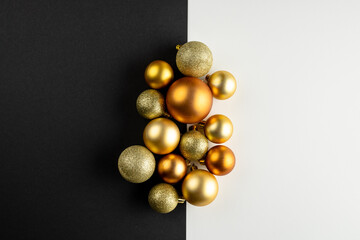 Composition of close up of new years baubles on black and white background