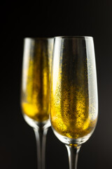 Composition of close up of new years champagne on black background