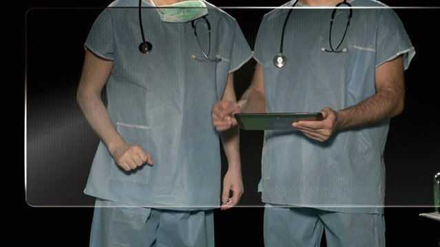 Surgeons working in hospital on touch screen