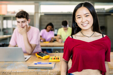 Portrait of young asian student woman smiling at camera standing at technology classroom