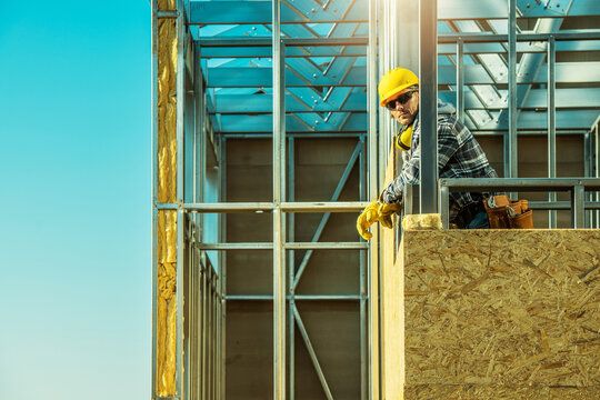 Construction Worker Proudly Standing at Building Site