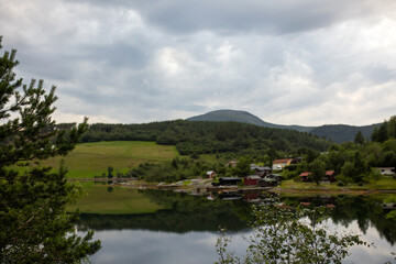 Family with children and dog, hiking in Litlefjellet on sunset, enjoying amazing view from the top of hiking trail