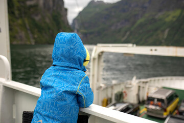 Family, kids and adults and a pet dog, enjoying trip to Geirangerfjord, amazing nature in Norway