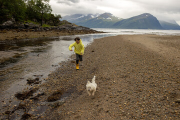 Children, running on the beach in the morning, playing, beach in Alesund, city in Norway