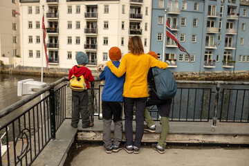 Family, kids, adults and dog, enjoying family vacation in Alesund, beautiful city in Norway - obrazy, fototapety, plakaty