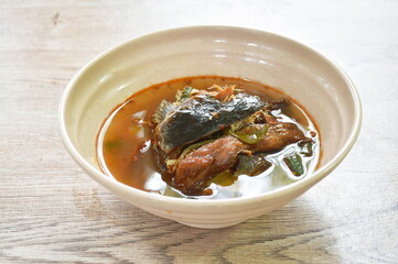 boiled smoked dry snake head fish in spicy and sour soup on bowl