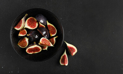 Figs in bowl on a black background