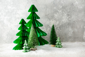 Green Chritmas tree decorations on light background holiday card