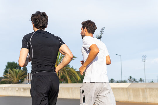 Anonymous Hispanic sportsmen running in park