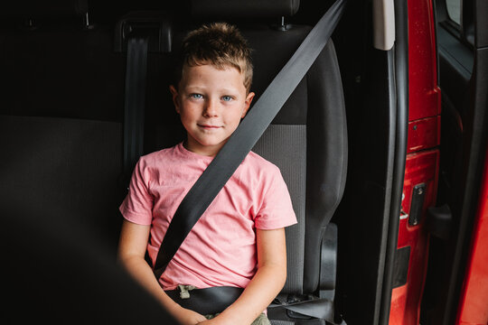 Happy Boy Sitting In Car