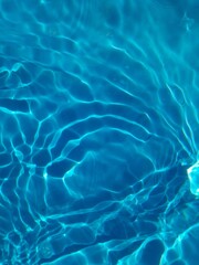 Defocus blurred transparent blue colored clear calm water surface texture with splashes and bubbles. Trendy abstract nature background. Water waves in sunlight with copy space. Blue watercolor shining