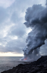 Volcanic lava flowing from nearby volcano into ocean