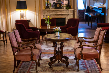 Luxury Victorian Antique styled interior. Beautiful vintage table and chairs. Classic room interior.