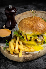 Homemade burger with grilled meat, vegetables, sauce. fast food meal. vertical image. top view. place for text