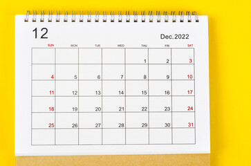 The December 2022 Monthly desk calendar for 2022 year on yellow background.