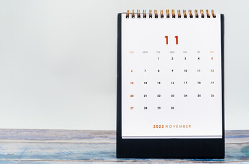 The November 2022 Monthly desk calendar for 2022 year on old blue wooden background