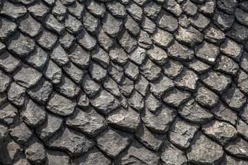 Background of black stone tiles made of volcanic rock