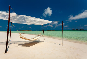 Hammock on the shoreline remote luxury paradise Island