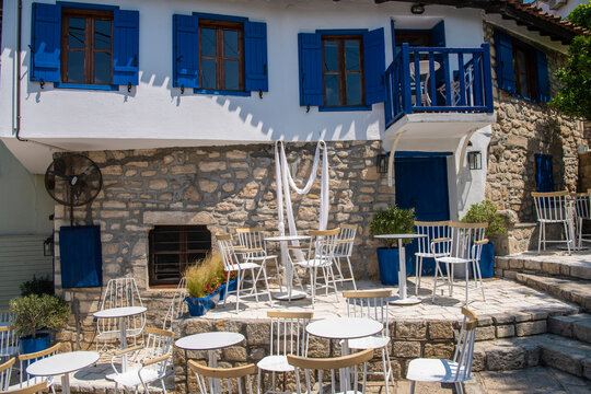 Restaurants and taverns next to sea in historical town. Situated on top of a hill the village of Afitos or Athitos, features stone houses and cobbled streets. Kassandra,Chalkidiki,Greece 27.06.2022