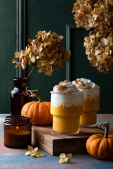 Spicy pumpkin latte with whipped cream. Autumn or winter hot coffee drink with cinnamon, nutmeg