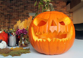 Jack's lantern is carved from a large orange pumpkin, a tradition to prepare various decorative...