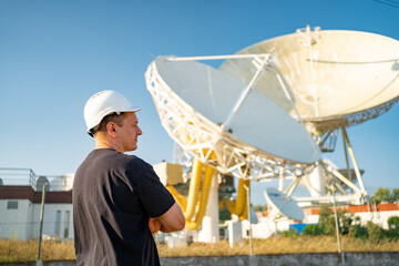 Engineer looking earth based astronomical radio telescope