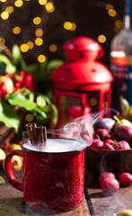 Mulled wine in a red mug on the autumn table