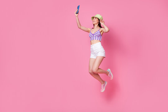 Full length photo of lady tourist jump high make selfie portrait wear panama shorts isolated pastel color background