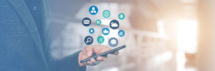 Businessman holding mobile phone to playing social media, Using the Application for Internet Communication and Information.