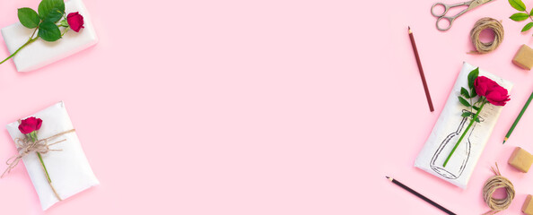 Set of wrapping paper and flowers for handmade on pink background. Homemade craft box gifts with painted vase, bouquet of red roses.