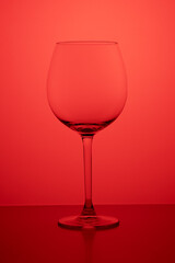 Empty glass of wine on an orange background