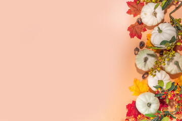 Autumn decorative pumpkins with fall leaves on beige background. Fall Thanksgiving halloween holiday greeting card background, harvest concept. Top view, copy space