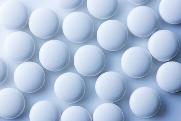 White medicine tablets or  pharmaceutical pills shot from above. 