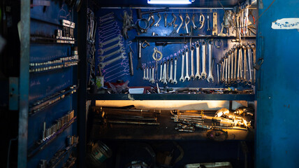Workshop scene. Tools  and wrenches close-up on the wall board.