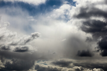atmosphere storm clouds with pieces of blue sky background