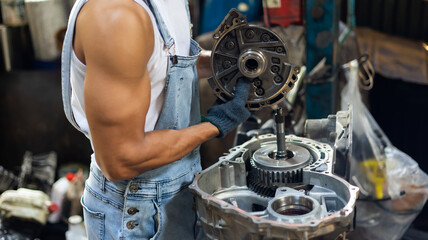Closeup hand and spanner. Big muscle car engine mechanic fixing repair car gear in car service garage