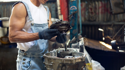 Closeup hand and spanner. Big muscle car engine mechanic fixing repair car gear in car service...