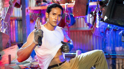 Fototapeta na wymiar Portrait sexy model asian male mechanic engineering with big muscle in a Car Service. Repair service specialist, technical maintenance