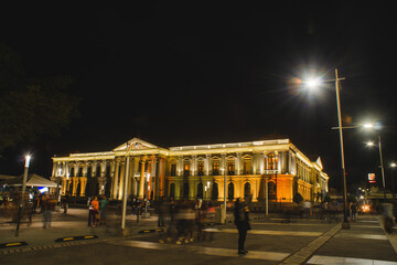 Fototapeta na wymiar National Palace of San Salvador at night on a rainy day