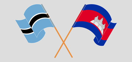 Crossed and waving flags of Botswana and Cambodia
