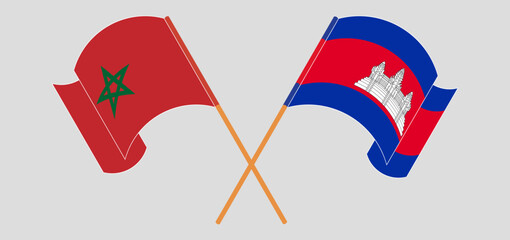 Crossed and waving flags of Morocco and Cambodia