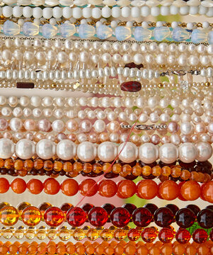 Beads and necklaces made of colored semi-precious stones.