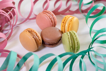 Group of macarons cakes of different pastel colors in white background. Culinary and cooking concept. Tasty colourful macaroons