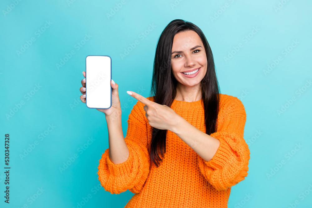 Aufkleber portrait of positive girl indicate finger demonstrate empty space telephone display isolated on cyan