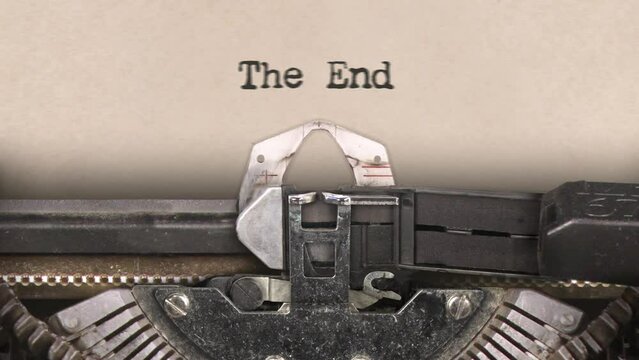 Old retro typewriter with sheet of paper. Close up. Writing text, words The End. Finish. With audio. 29,97 fps