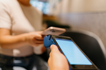 woman pay with smartphone