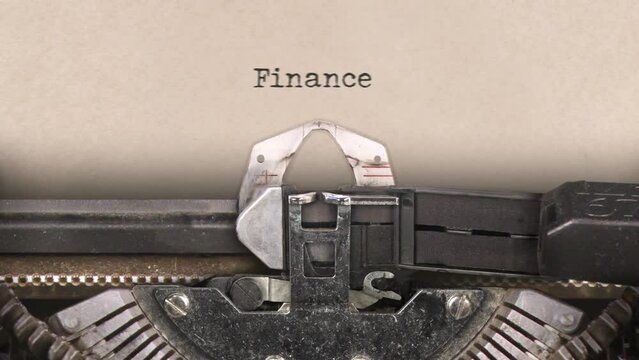 Old retro typewriter with sheet of paper. Close up. Word. Writing text Finance. With machine sounds. 29,97 fps