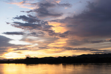 Naklejka na ściany i meble Horizon panorama mountain and river with dramatic twilight sky and cloud sunset background.