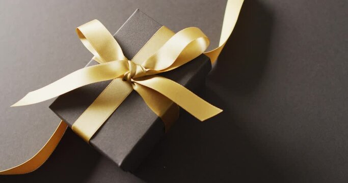 Video of christmas gift and copy space on black background